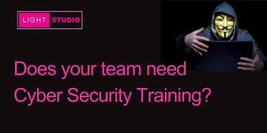 A black background with a cyber scammer in a hood and mask, does your team need cyber training?