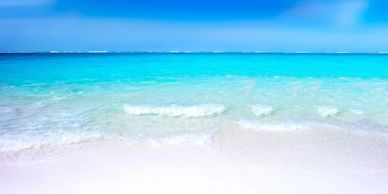 Shoreline with a turquoise sea and blue sky