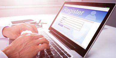 A male completing a registration on his laptop