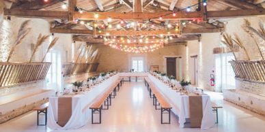 A large venue with two long tables laid out ready for an event