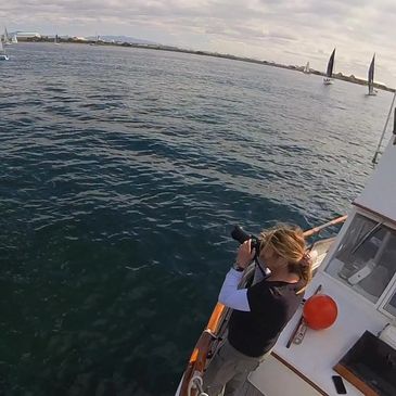 Action shot in San Diego videographing the start line of a saling regatta.
