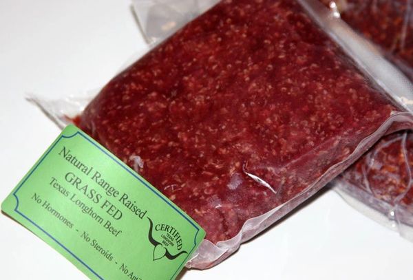 Packaged grass-fed ground beef with label.