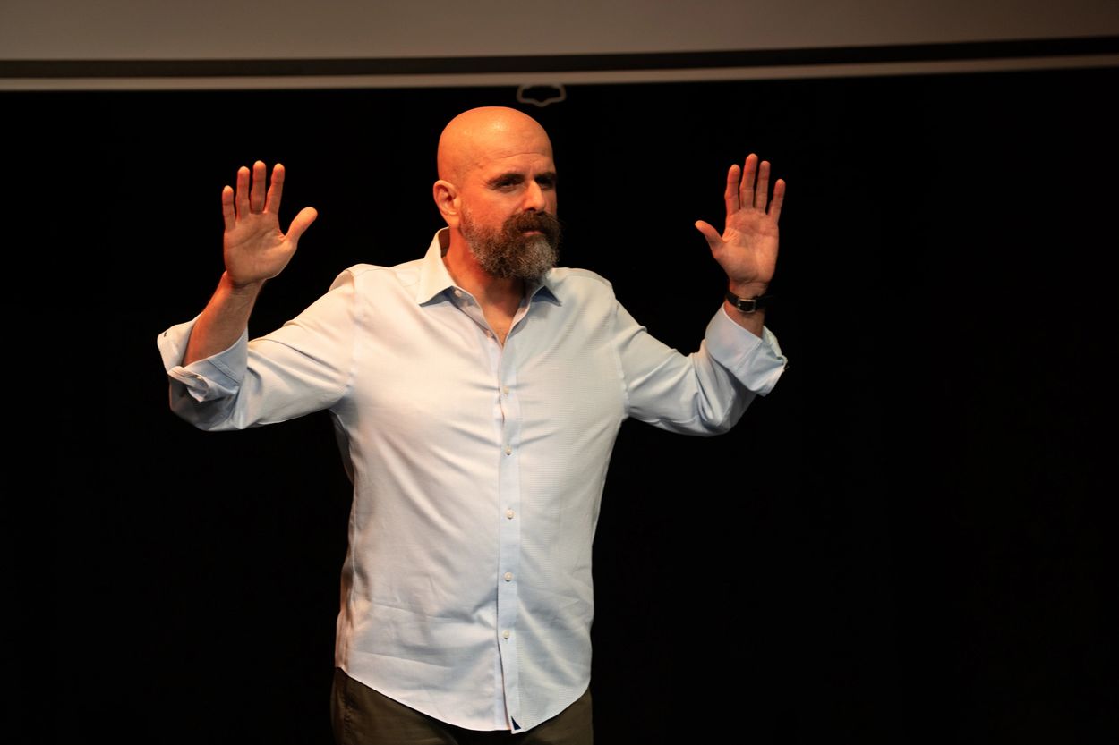 Haig "Hike" Chahinian raising his palms on either side of his head.