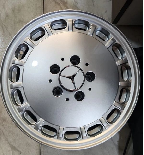 Silver Mercedes-Benz alloy wheel with iconic logo at center.
