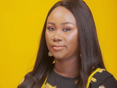 Author photo of Adebusola Dele-Davids posing against a yellow background. 