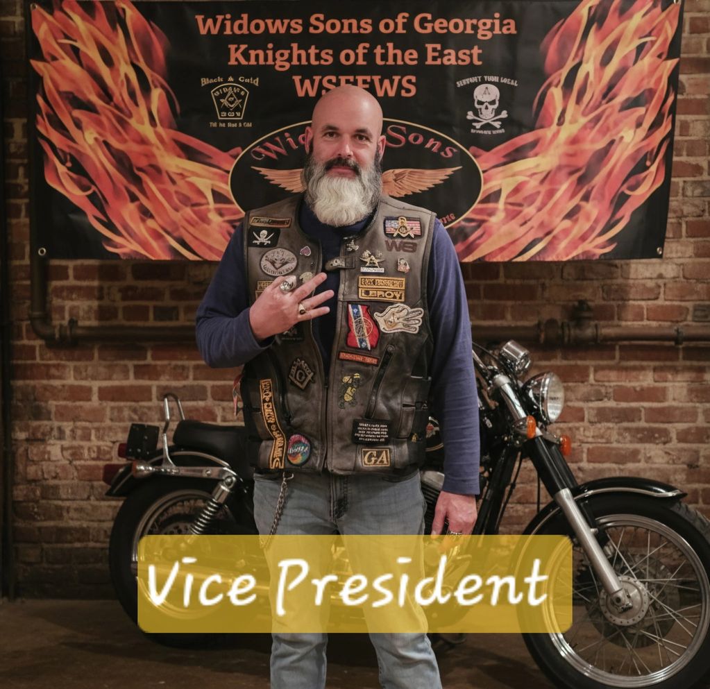 Bearded man in biker vest poses as Vice President of Widows Sons of Georgia.