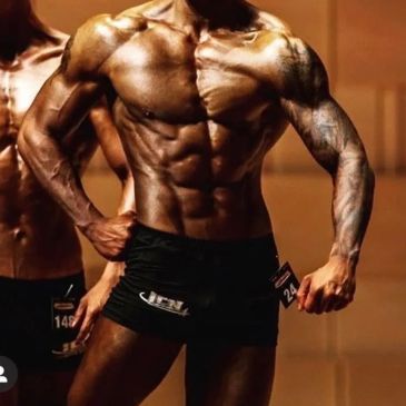 Muscular man posing in bodybuilding competition.