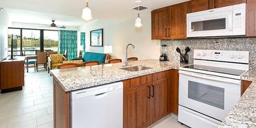 Modern kitchen with wooden cabinets and granite countertops.