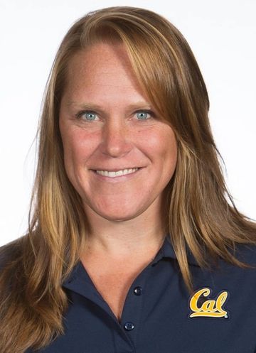 Smiling woman with light brown hair and blue eyes against a white background.