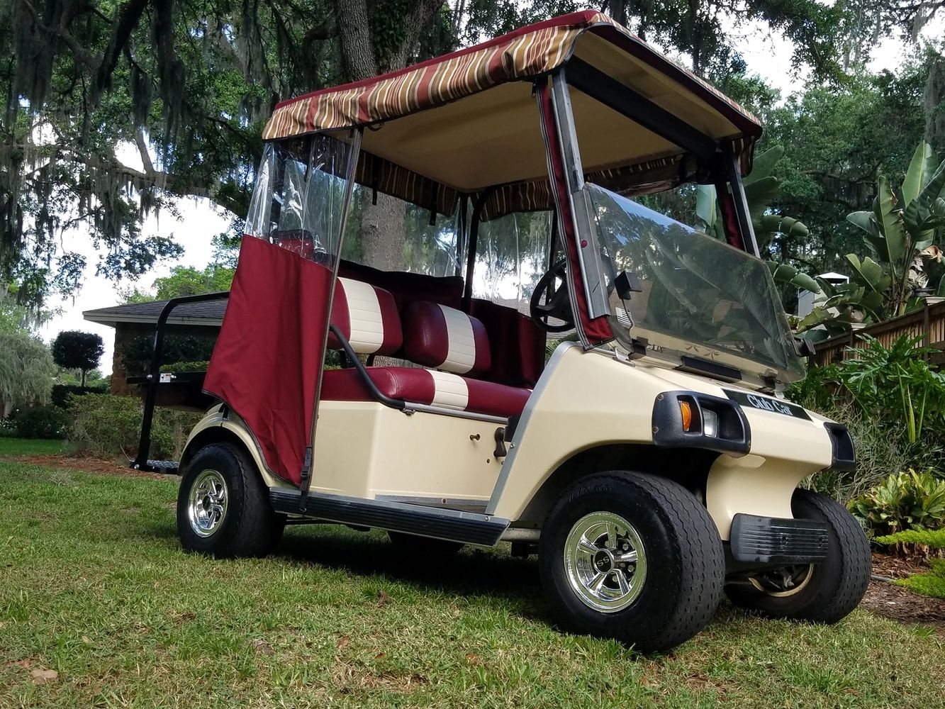 Red golf cart with tan roof
