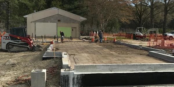 Construction site with foundation work in progress.