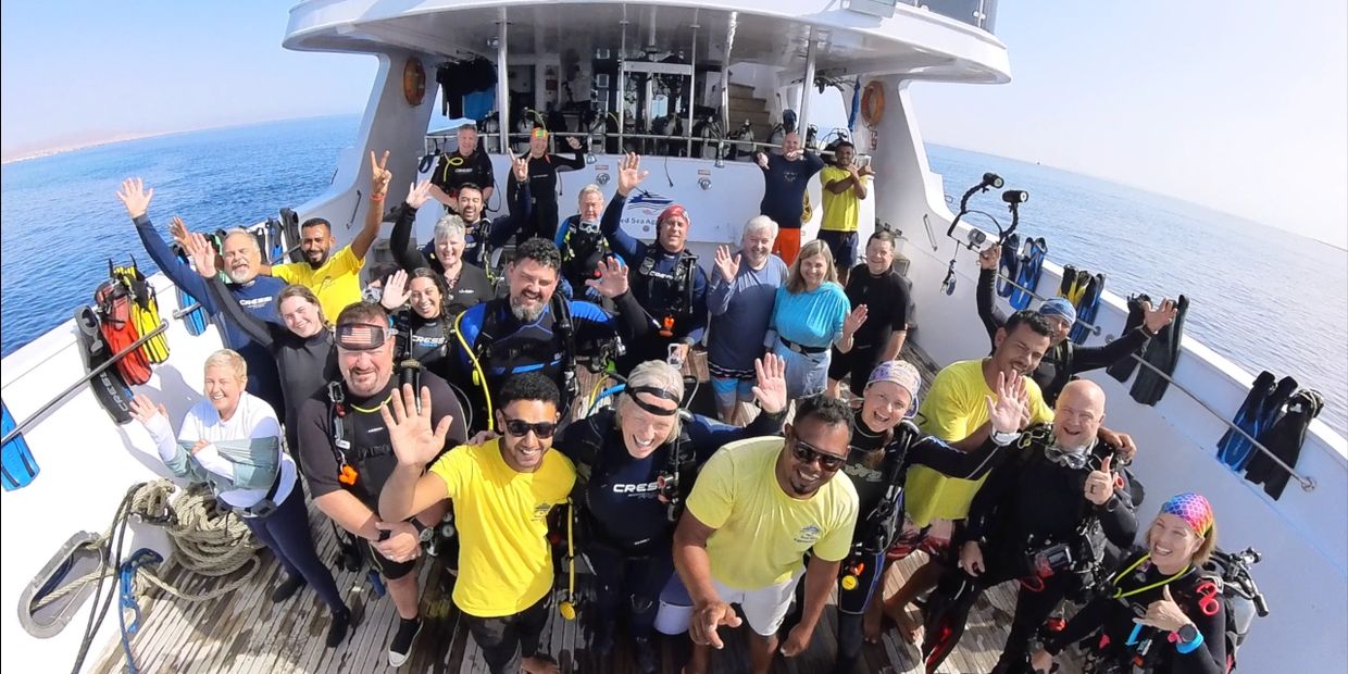 A group of scuba divers on a dive boat. 