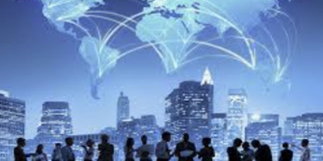 Silhouetted business people networking with a global digital map above city skyline.