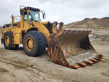Large yellow bulldozer on dirt terrain.