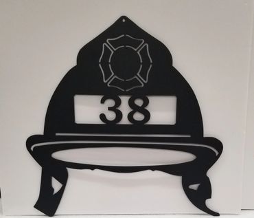 Black firefighter helmet wall decoration with number 38.
