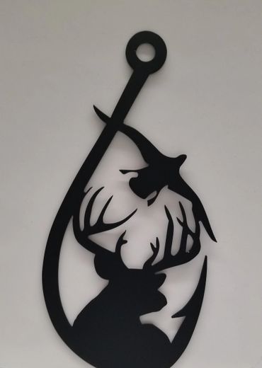 Black metal wall art of a deer head inside a fishing hook.