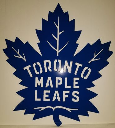 Blue Toronto Maple Leafs logo cutout on a beige background.