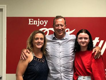 Friends standing in a relaxed pose while looking at the camera