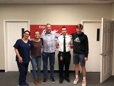Young friends standing together and looking directly at the camera