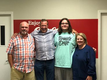 Diverse group of friends standing close and smiling at the camera