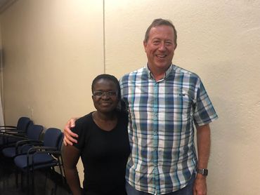 Man with woman side by side and looking into the camera