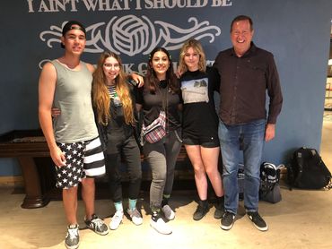 Happy group of friends standing outdoors and facing the camera