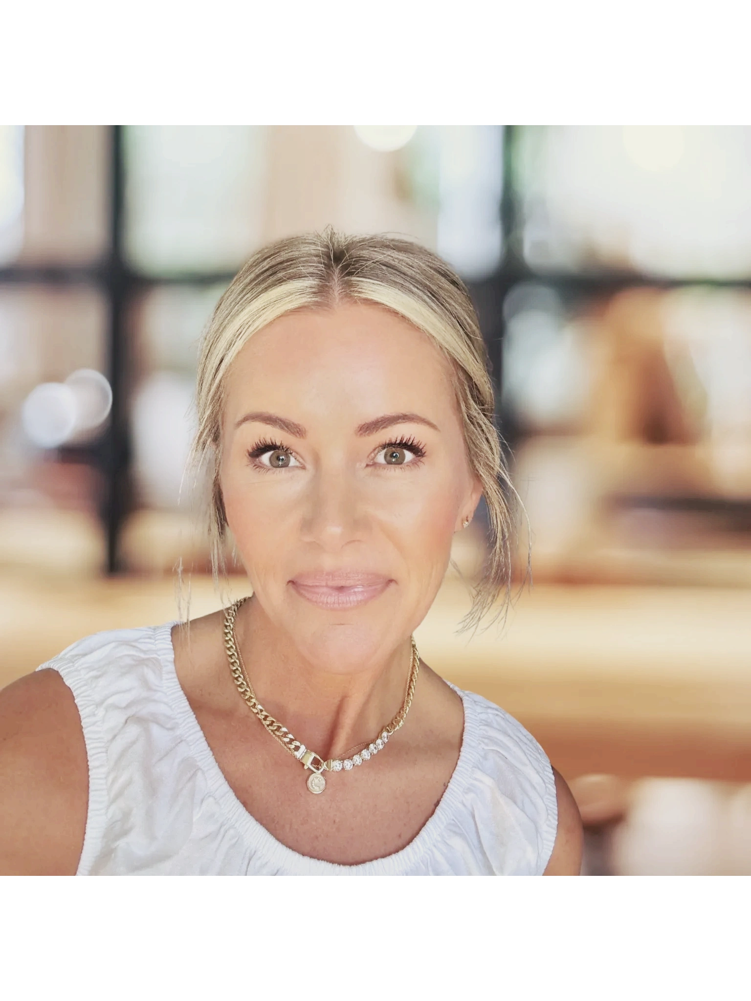 Woman practicing yoga on the beach at sunrise.