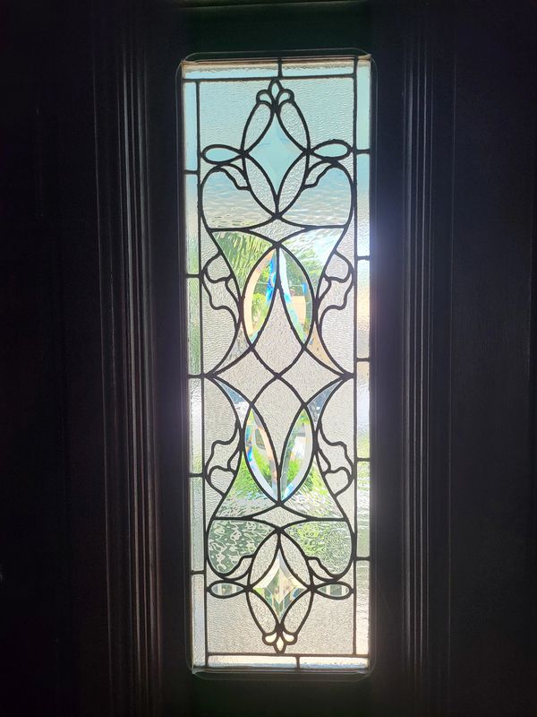 Decorative stained glass window with floral design.