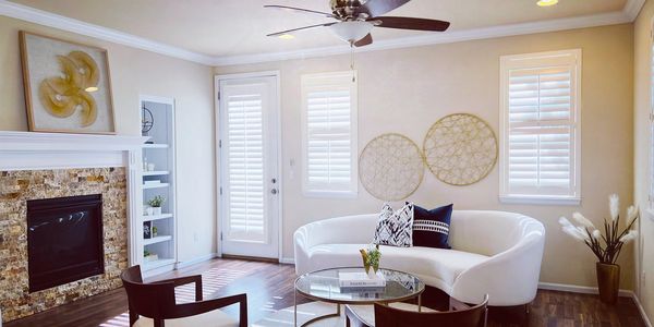 Homeowners discussing with staging professionals about their house's layout.