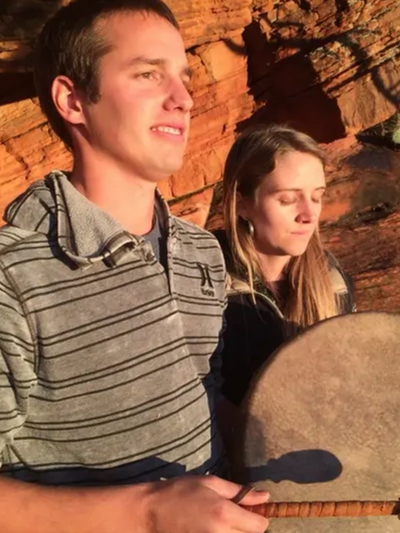 A couple playing a scared drum and meditating in Sedona, AZ.