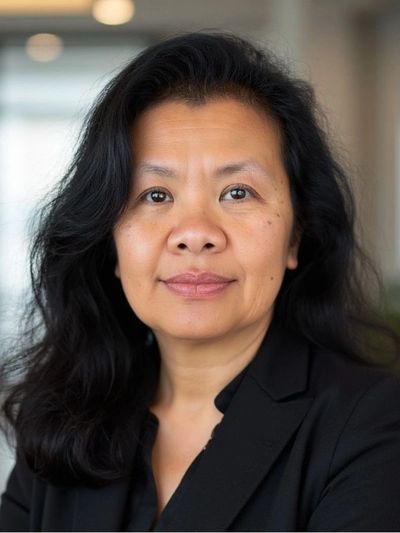 Professional woman with long black hair wearing a black blazer.