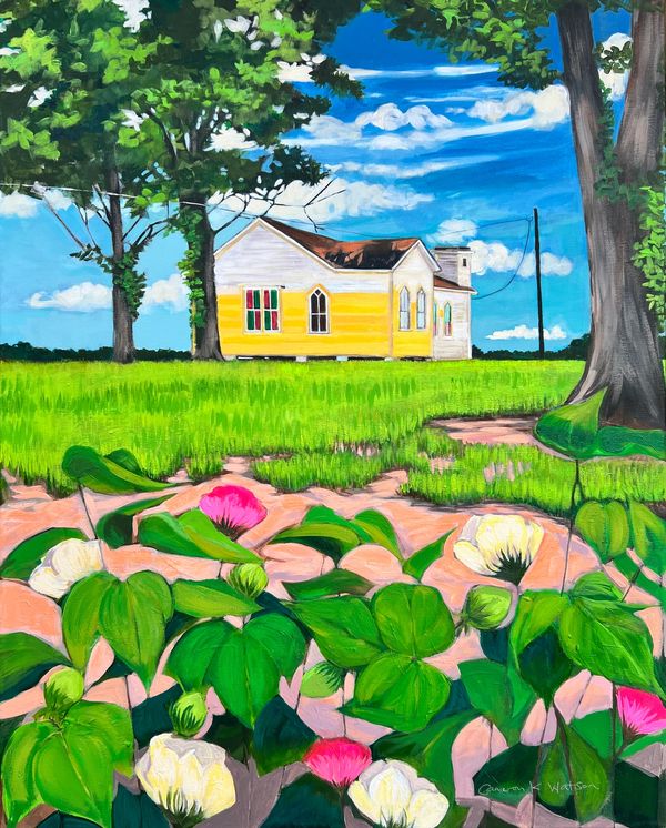 Bright yellow house behind green plants and trees under a blue sky.