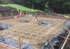 Preparing the foundation with vapor barrier, gravel, sand and structural steel.