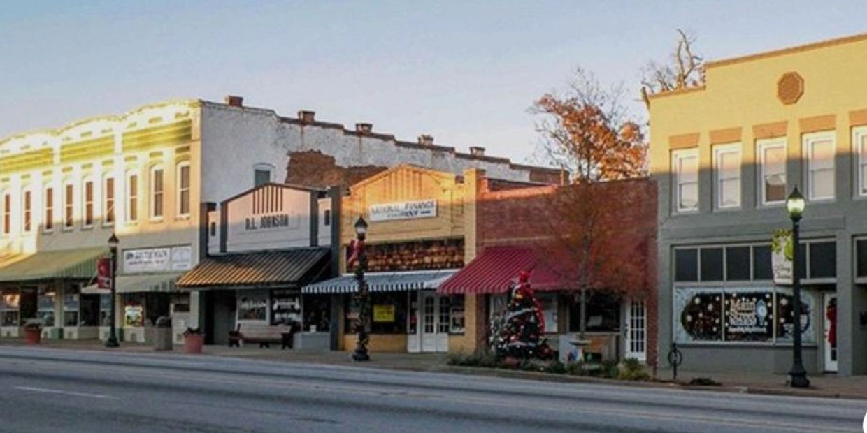 Quiet small town street with vintage storefronts and holiday decorations.