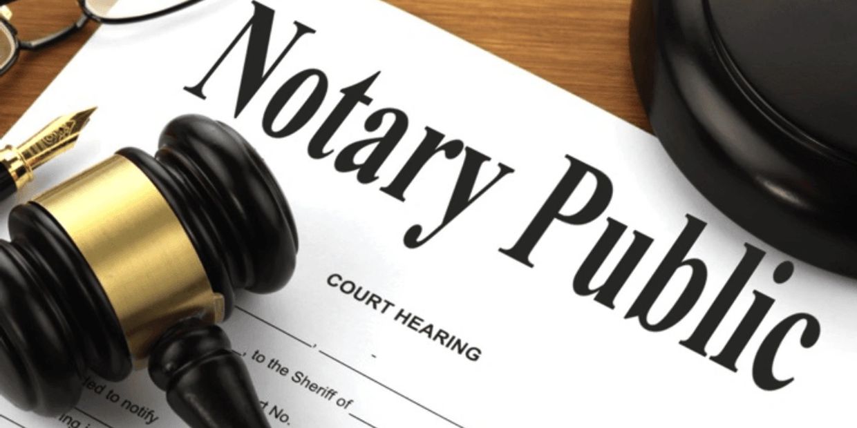 Close-up of a notary public document with a judge's gavel and pen.
