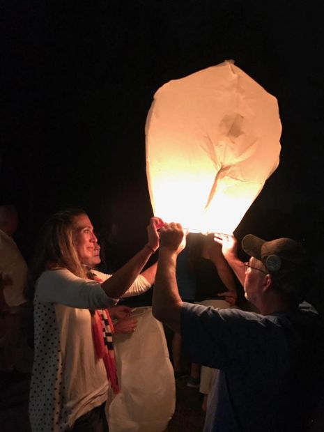 Sending sky lanterns with personalized good-byes written on 