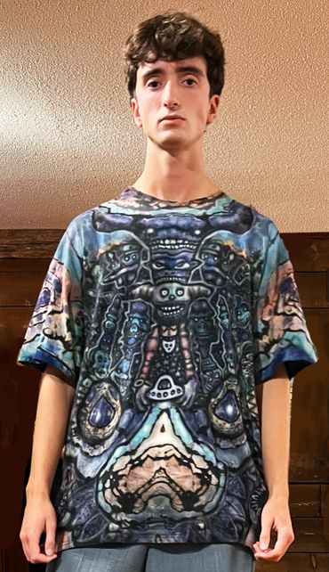 Young man wearing a colorful, abstract patterned t-shirt.
