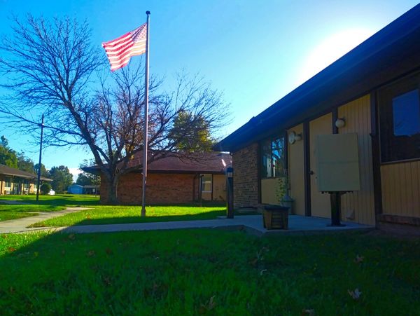 American flag flying outside a residential building on a sunny day.
