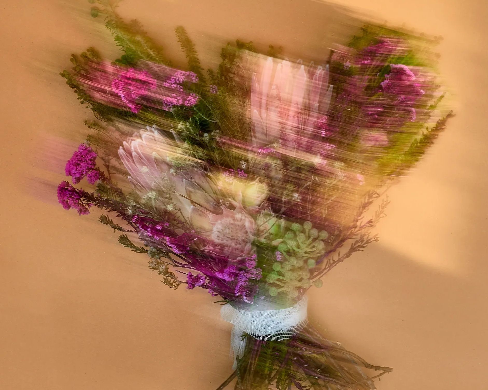 Blurred bouquet of flowers with pink and purple hues.
