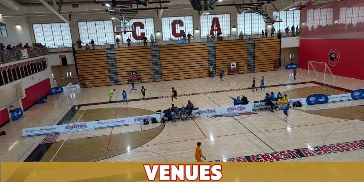 Indoor futsal game in a large gymnasium with spectators.