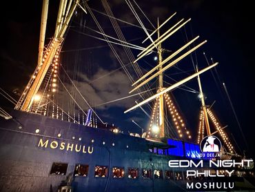 Night view of the illuminated ship Mosulu with EDM Night Philly logo.