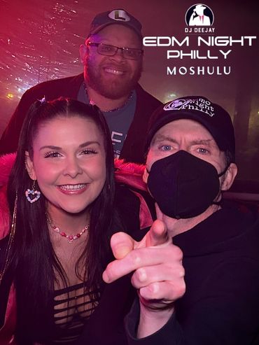 Three friends smiling and posing at EDM Night Philly event at Moshulu.