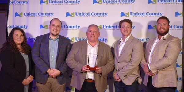 Group photo of five people at Unicoi County Chamber of Commerce event.