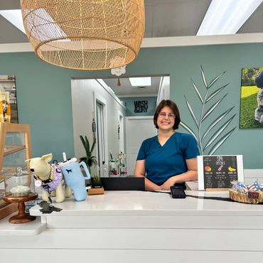 Smiling receptionist at a clinic front desk.