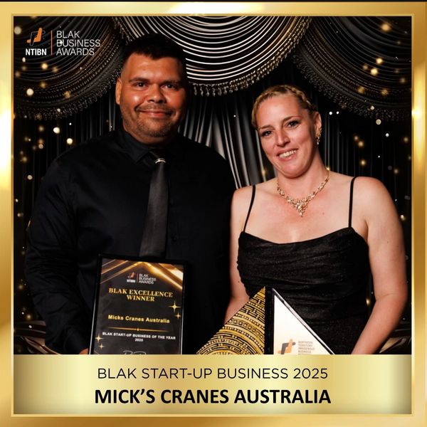 Two award winners hold plaques at the Blak Business Awards 2025.