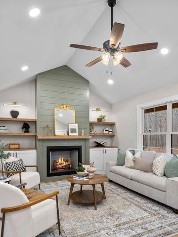 Cozy living room with a fireplace and modern decor.