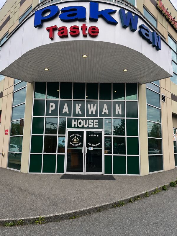 Front entrance of Pakwan Taste restaurant with large glass windows and bold signage.