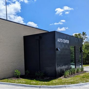 Exterior of an auto center building under a blue sky.