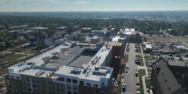 Aerial view of a suburban area with new buildings and streets.