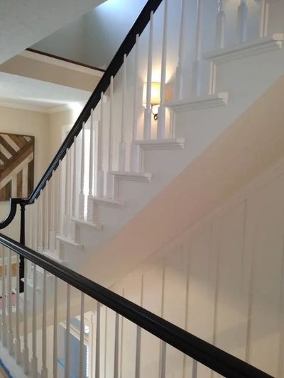 Staircase painted white with a black railing